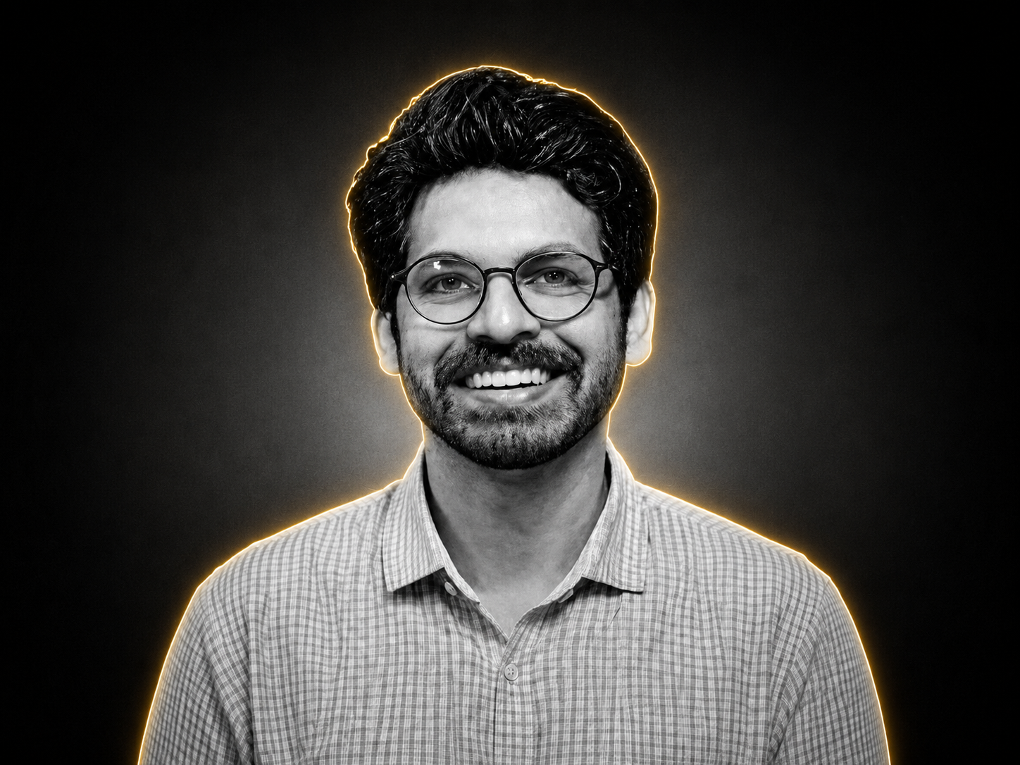 Owner of Altaswiq Agencia Mohammad Talib Khan, a smiling man with glasses, portrait with glowing orange outline